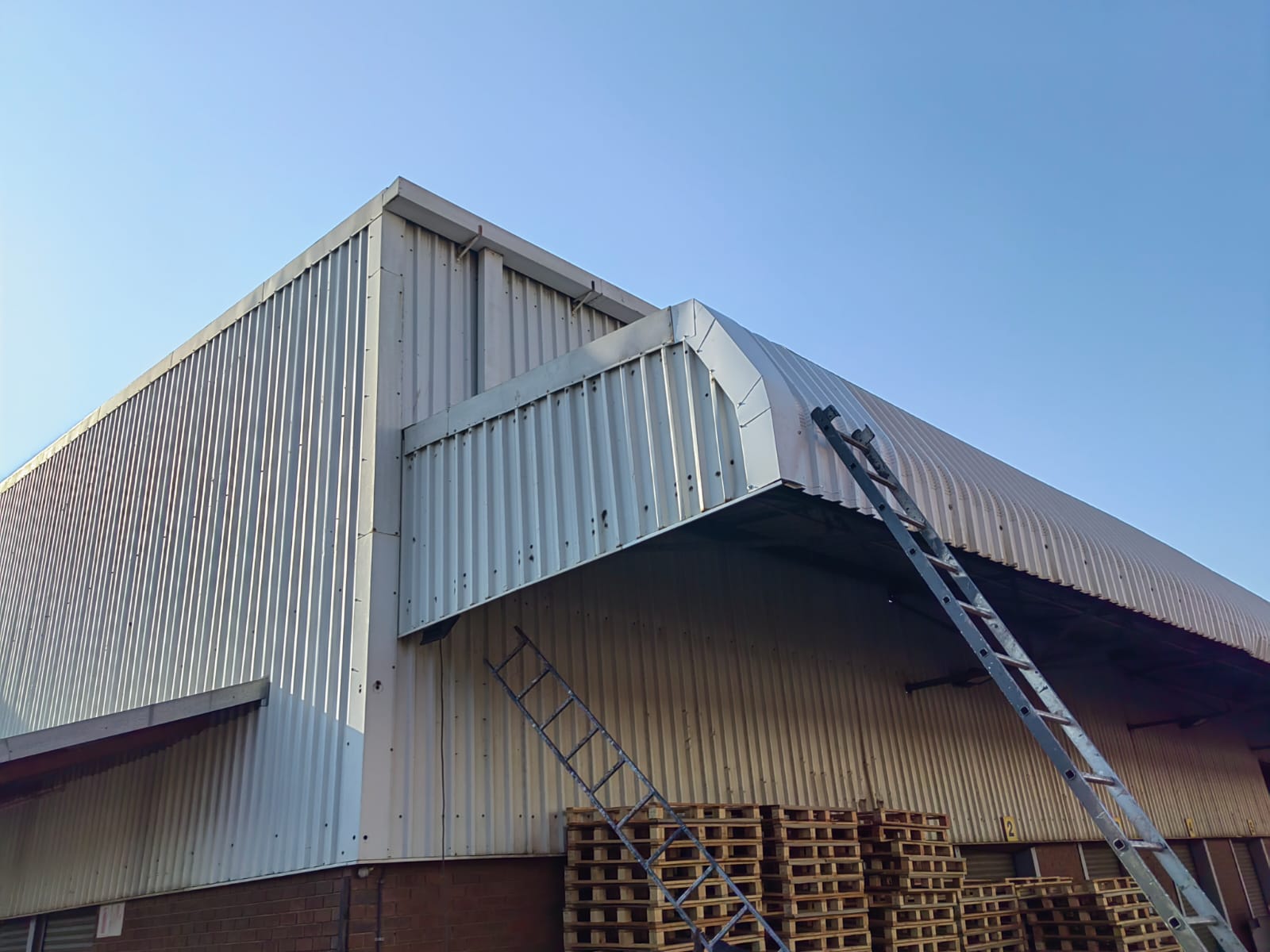 Factory roof sheeting replacement in progress